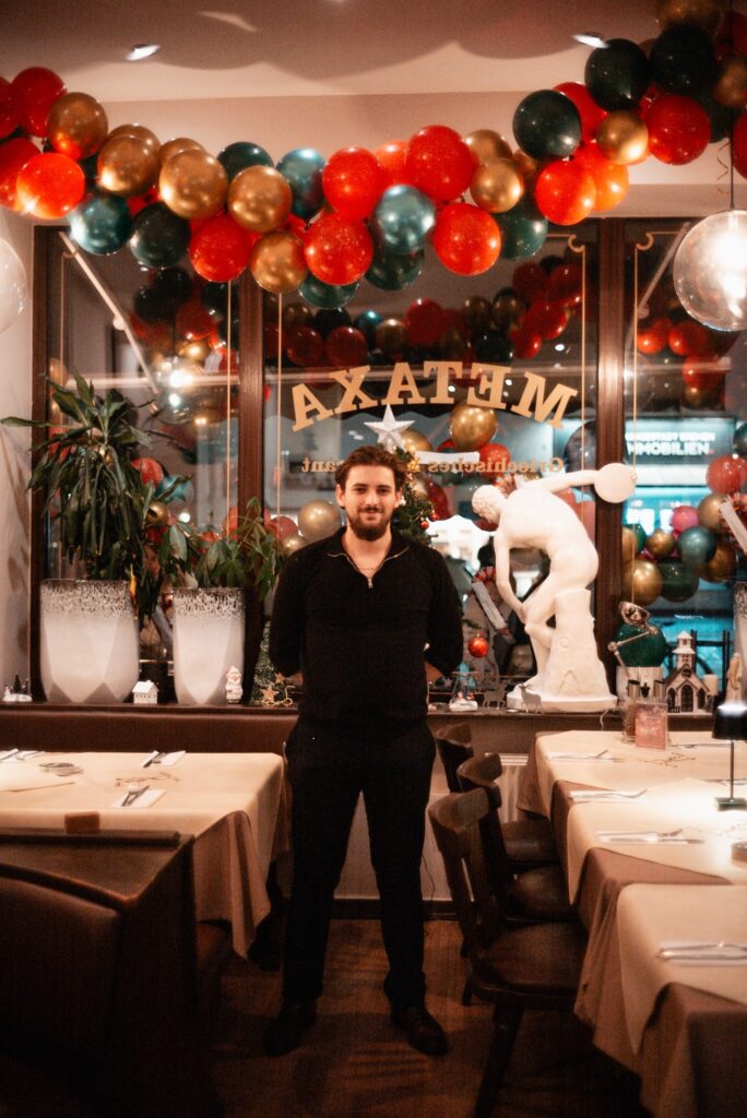 Der Inhaber in seinem Restaurant mit festlicher Dekoration