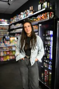 Die Inhaberin des Kiosks steht in Ihrem Geschäft